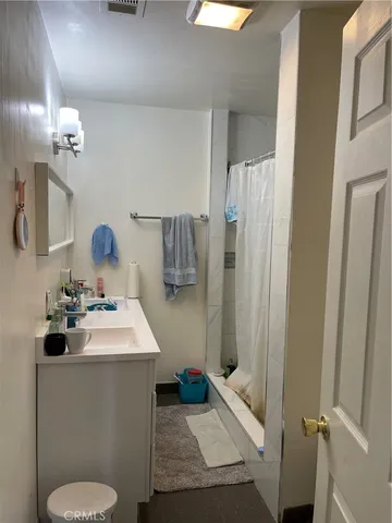 a bathroom with a sink a toilet and mirror