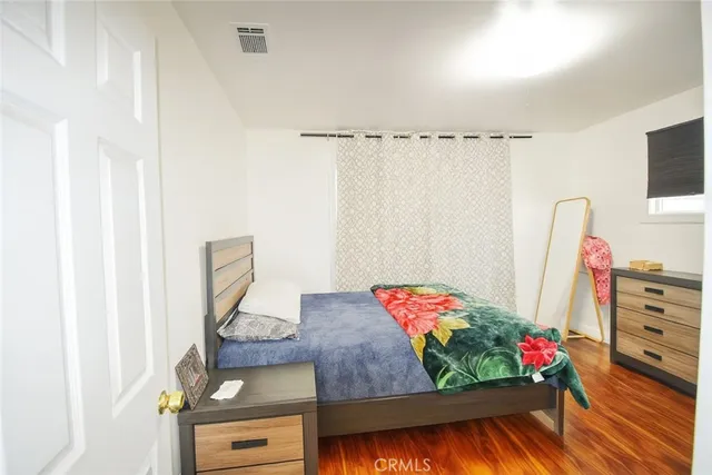 a bedroom with a bed and a dresser