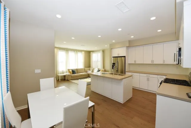 a kitchen with sink refrigerator and window