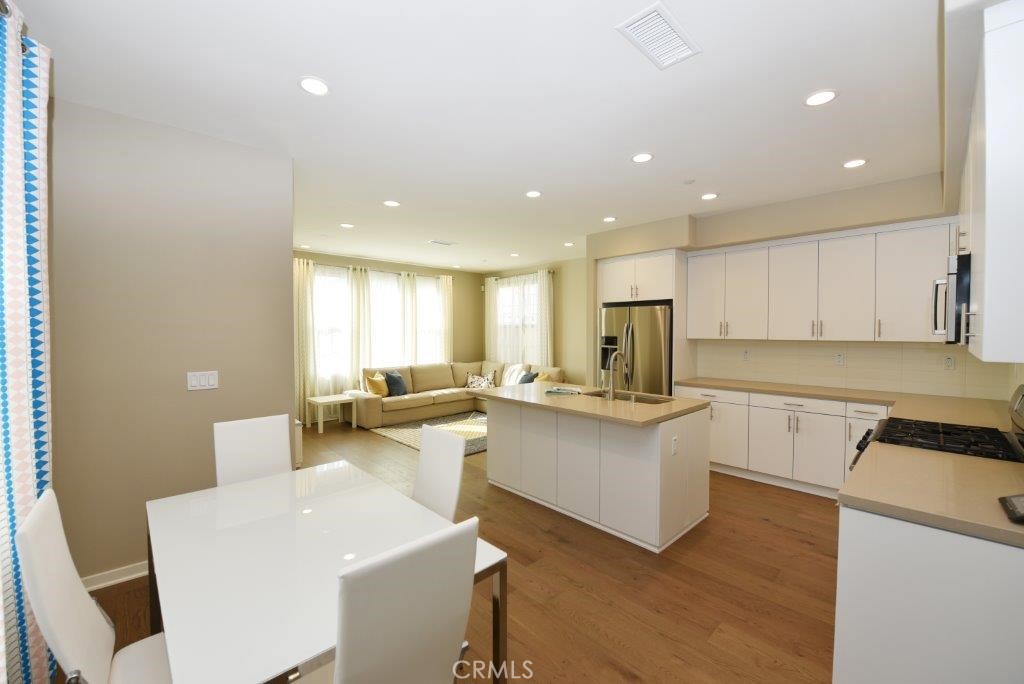 338 Floral View Irvine, CA 92618 - Photo 14 of 23 a kitchen with a sink and white cabinets