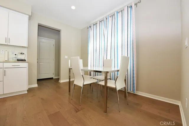 a view of living room with furniture and wooden floor