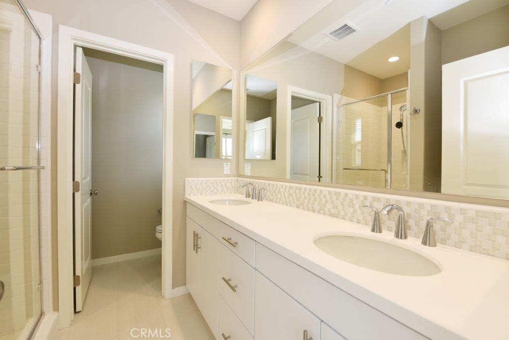 338 Floral View Irvine, CA 92618 - Photo 19 of 23 a bathroom with a sink double vanity and a mirror