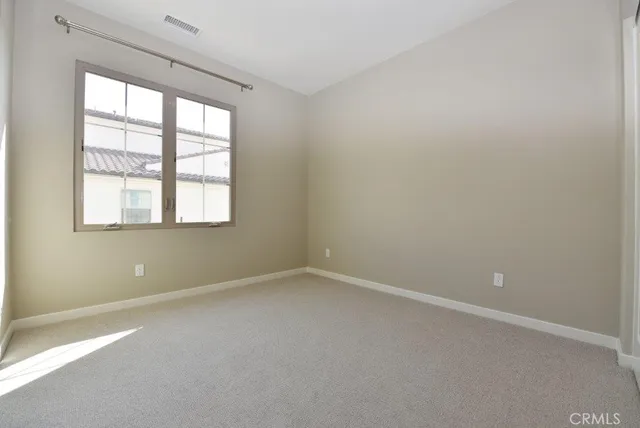 an empty room with windows and bathroom