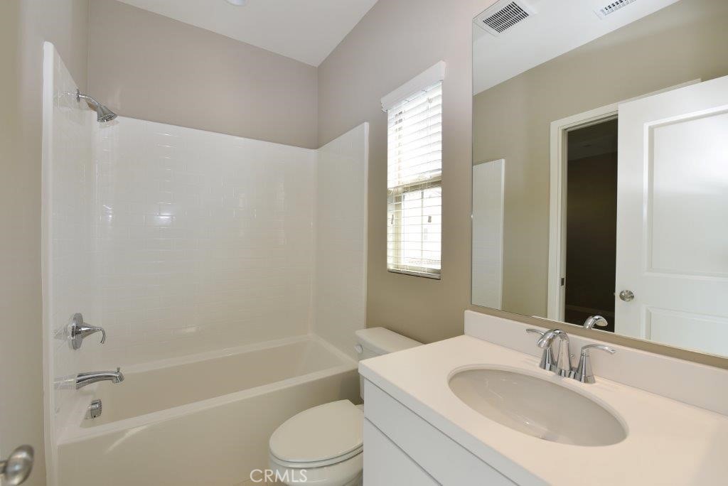 338 Floral View Irvine, CA 92618 - Photo 22 of 23 a bathroom with a bathtub shower sink vanity mirror and toilet