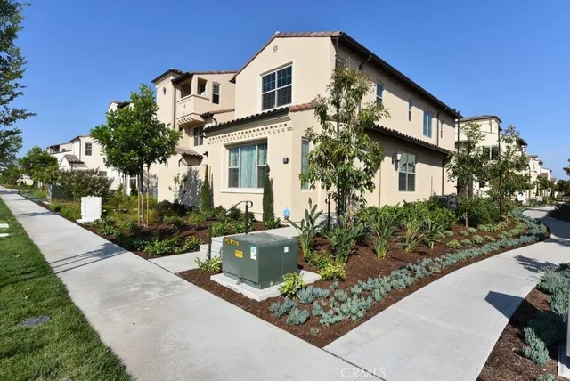 a living room with furniture and kitchen view with wooden floor