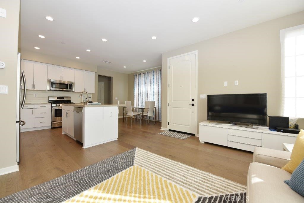 338 Floral View Irvine, CA 92618 - Photo 5 of 23 a living room with stainless steel appliances furniture and a flat screen tv