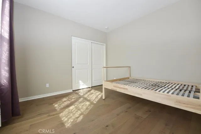 a view of a room with wooden floor and cabinet