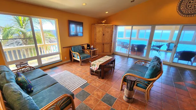 a living room with furniture and a floor to ceiling window