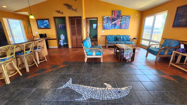 a living room with furniture a rug and a painting