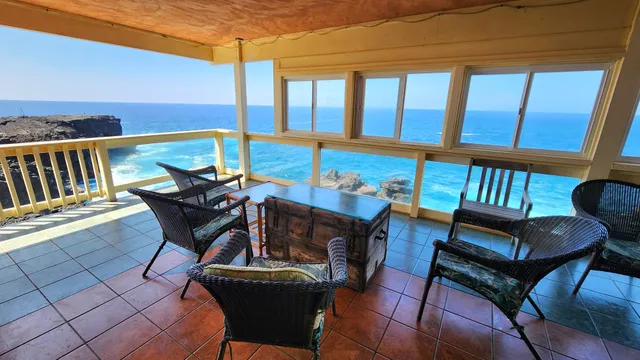 a view of a chairs and table in the balcony