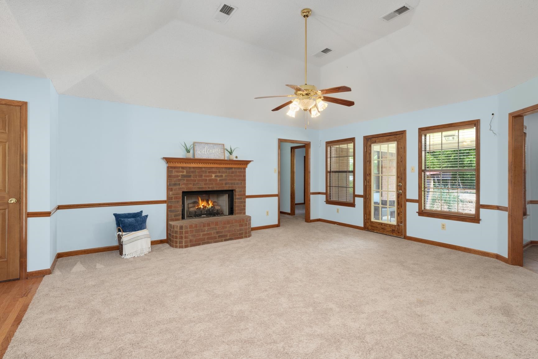 478 McQuiston Road Brighton, TN 38011 - Photo 6 of 37 Unfurnished living room featuring ceiling fan, light hardwood / wood-style flooring, a fireplace, and lofted ceiling