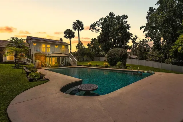a view of a swimming pool with a yard