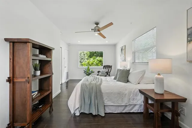 a view of a house with backyard and trees