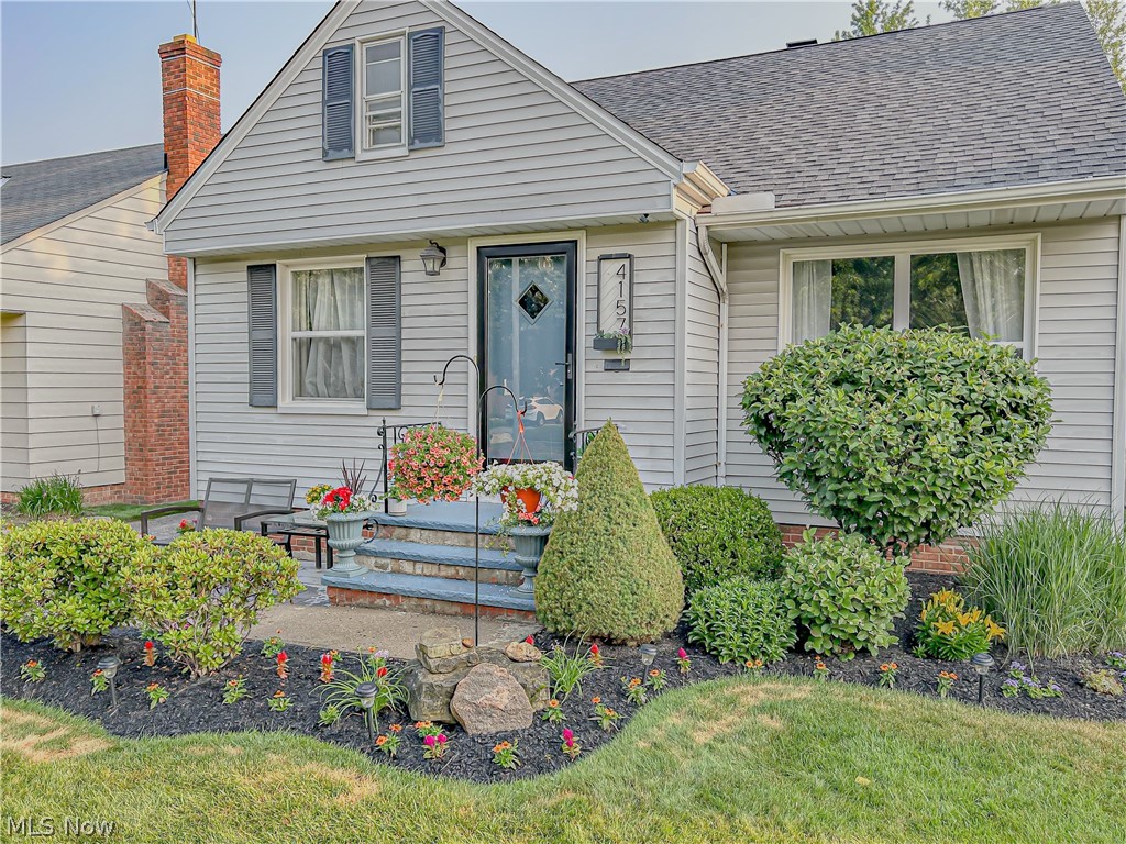 4157 Verona Road Cleveland, OH 44121 - Photo 2 of 26 View of front facade featuring roof with shingles and a front lawn