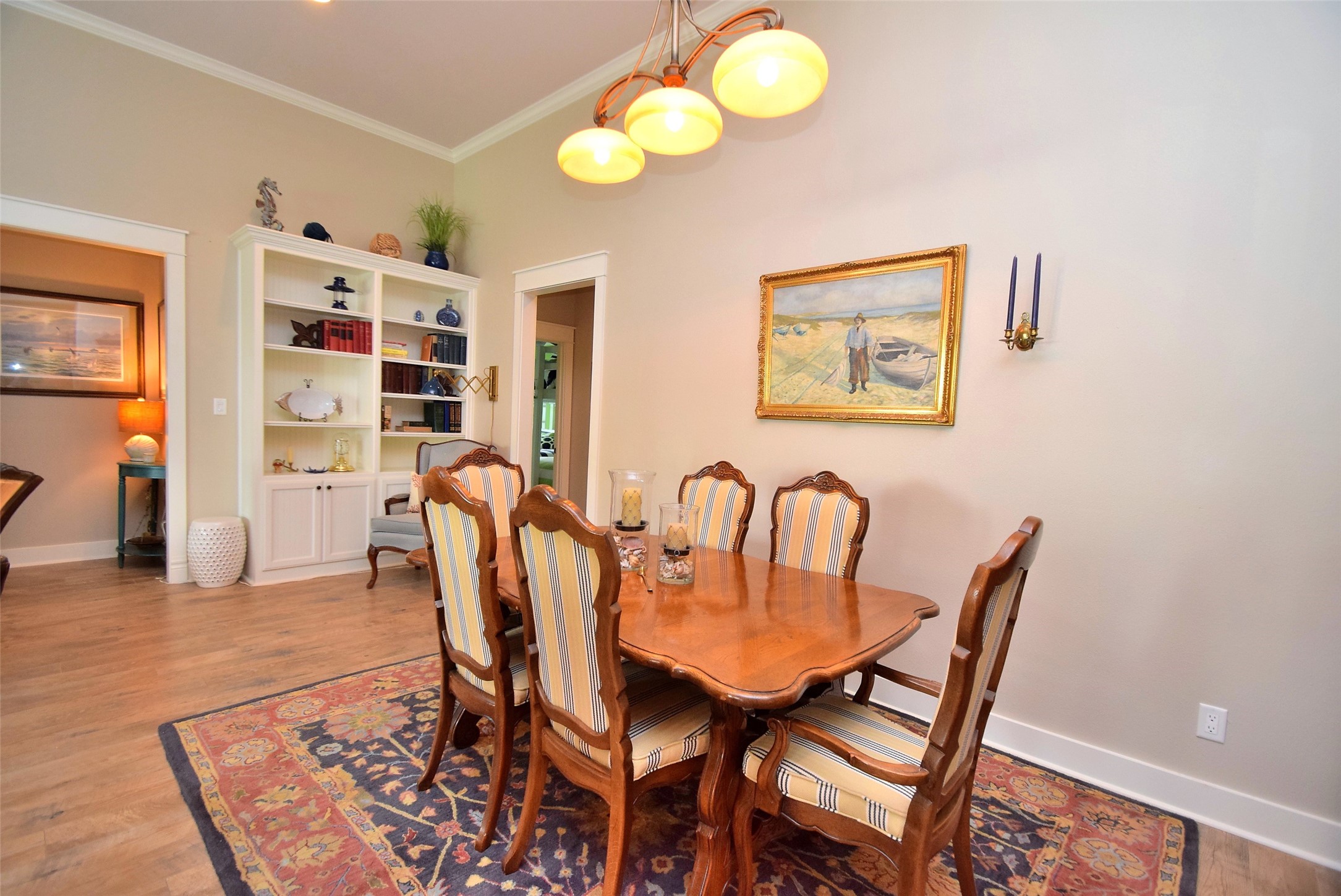 956 South Redfish Crystal Beach, TX 77650 - Photo 12 of 20 a view of a dining room with furniture and wooden floor