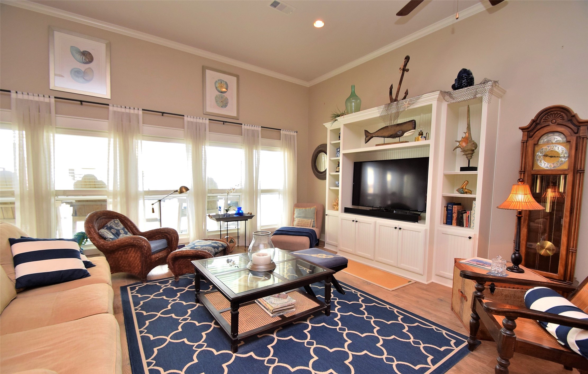 956 South Redfish Crystal Beach, TX 77650 - Photo 13 of 20 a living room with furniture a flat screen tv and a floor to ceiling window