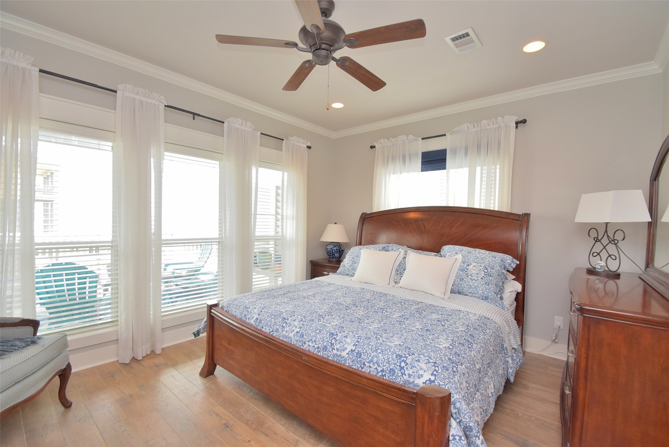 956 South Redfish Crystal Beach, TX 77650 - Photo 15 of 20 a bedroom with a large bed and a chandelier
