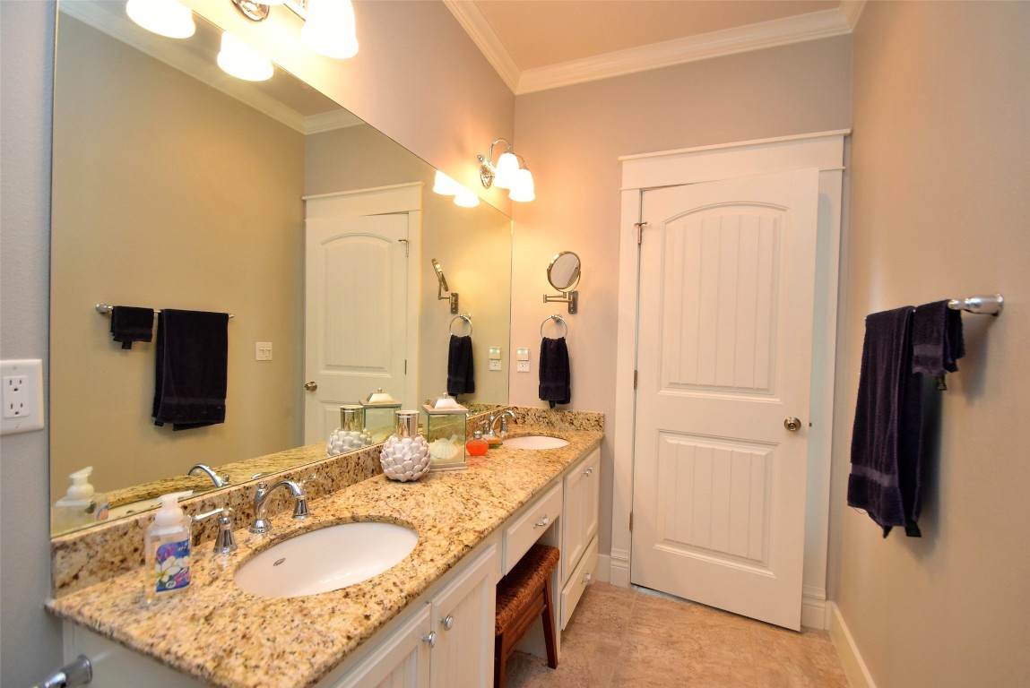 956 South Redfish Crystal Beach, TX 77650 - Photo 17 of 20 a bathroom with a granite countertop sink and a mirror