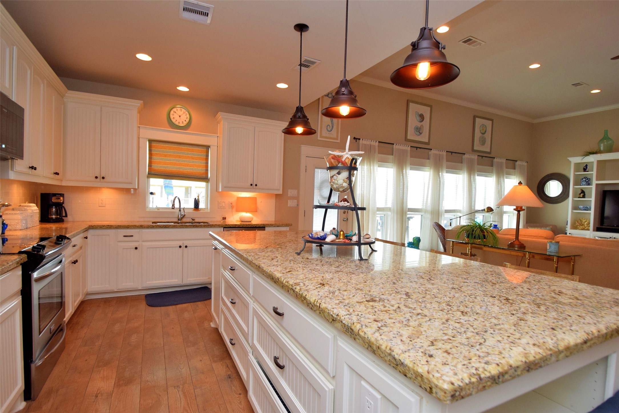 956 South Redfish Crystal Beach, TX 77650 - Photo 8 of 20 a kitchen with stainless steel appliances granite countertop a sink and a white cabinets