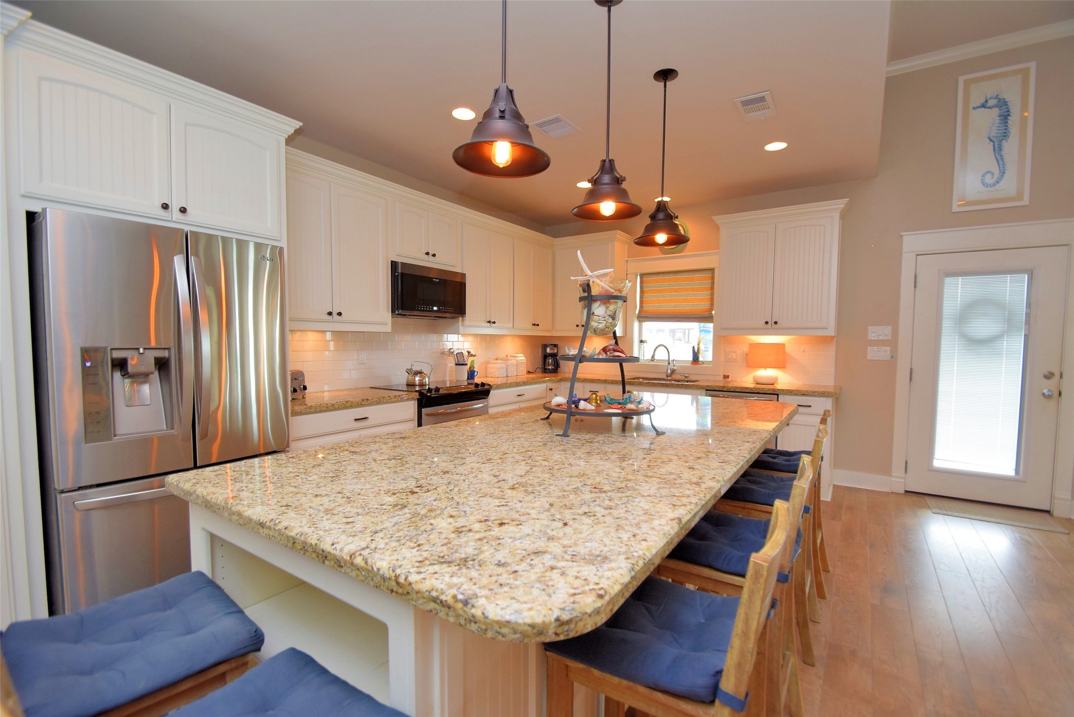 956 South Redfish Crystal Beach, TX 77650 - Photo 10 of 20 a kitchen with center island and stainless steel appliances