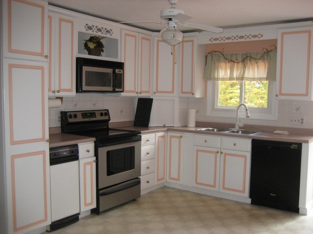 53 Breakneck Road Sturbridge, MA 01566 - Photo 14 of 22 a kitchen with white cabinets and a stove top oven