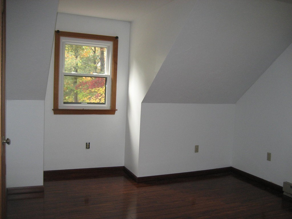 53 Breakneck Road Sturbridge, MA 01566 - Photo 19 of 22 a view of an empty room with wooden floor and a window