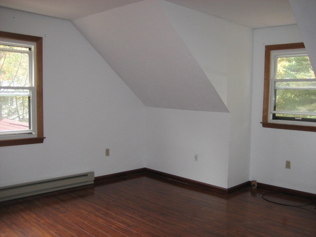 53 Breakneck Road Sturbridge, MA 01566 - Photo 20 of 22 an empty room with wooden floor and windows