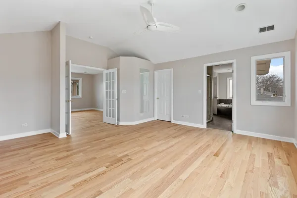 a view of empty room with wooden floor