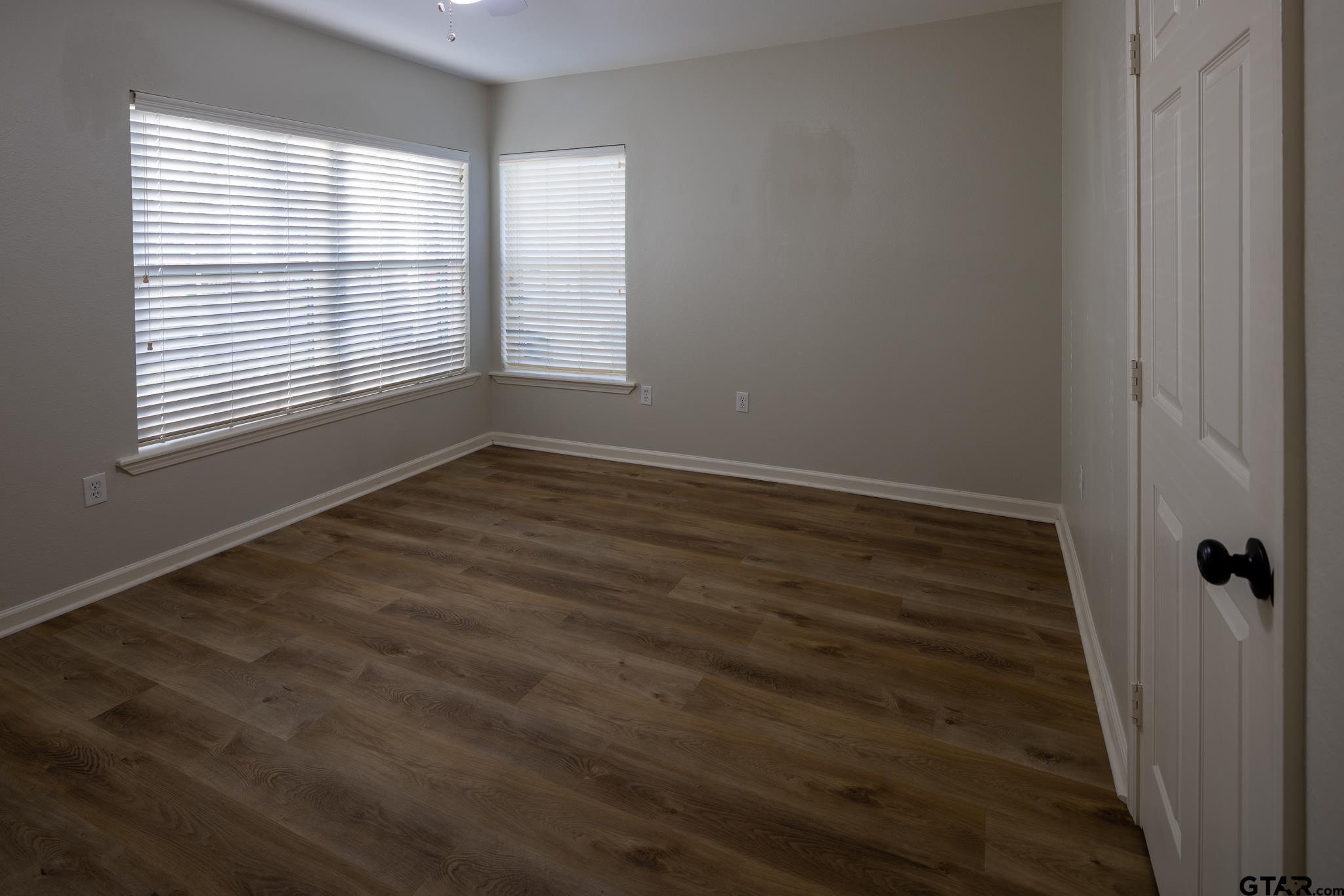 2802 Pollard Drive Tyler, TX 75701 - Photo 15 of 38 wooden floor in an empty room with a window