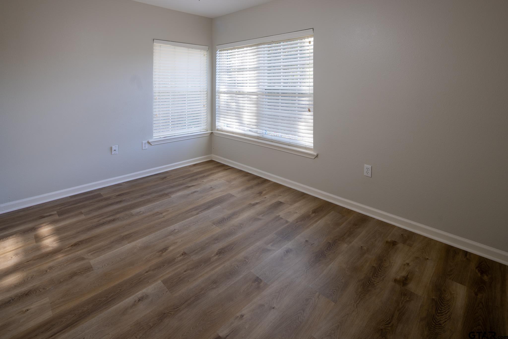 2802 Pollard Drive Tyler, TX 75701 - Photo 17 of 38 a view of an empty room with wooden floor and a window
