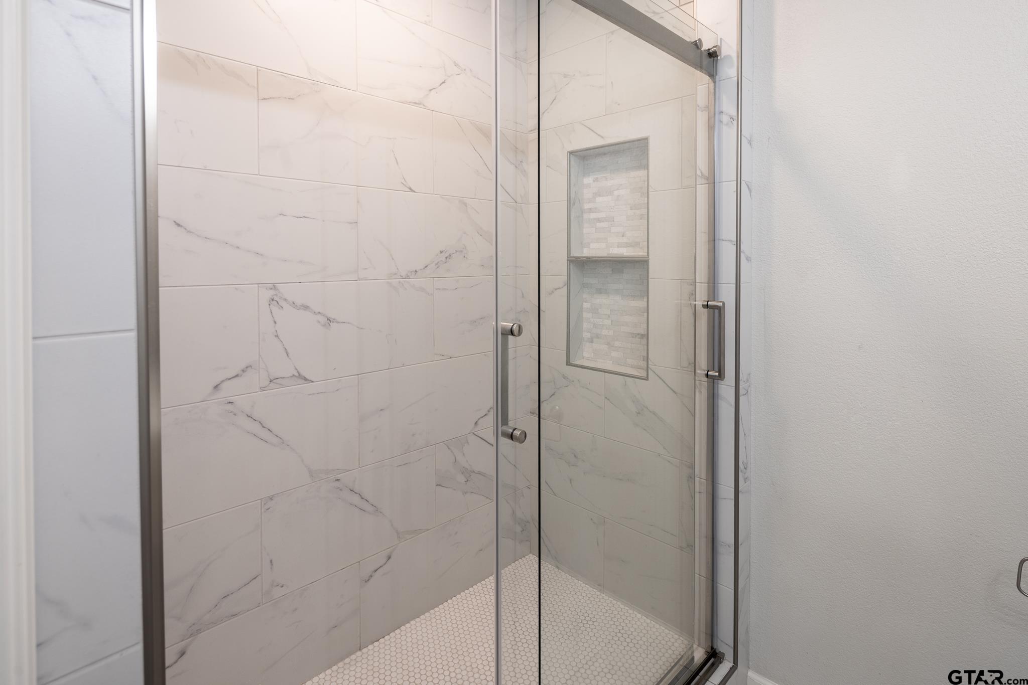 2802 Pollard Drive Tyler, TX 75701 - Photo 18 of 38 a bathroom with a glass shower door