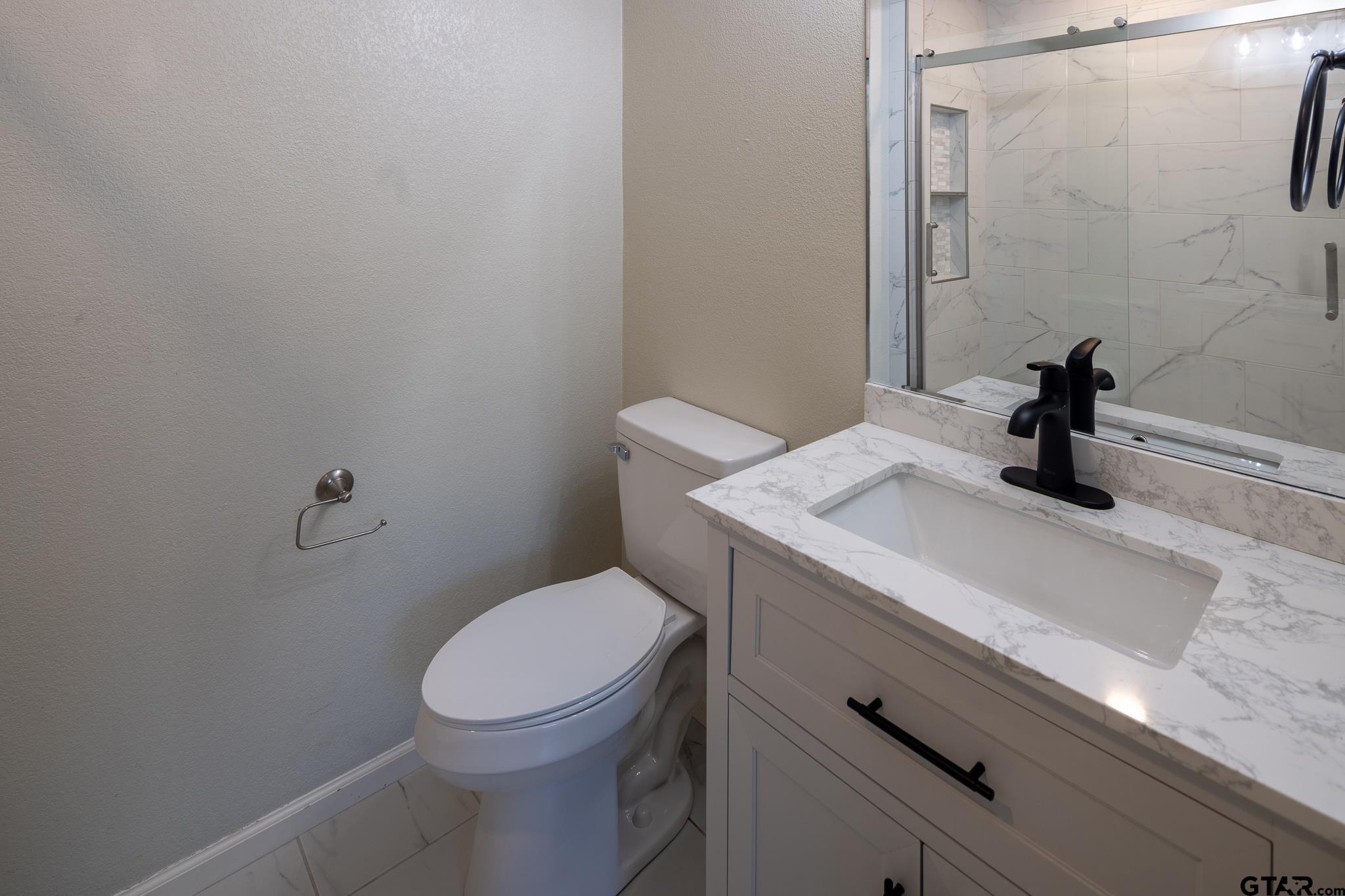 2802 Pollard Drive Tyler, TX 75701 - Photo 19 of 38 a bathroom with a sink a toilet and shower