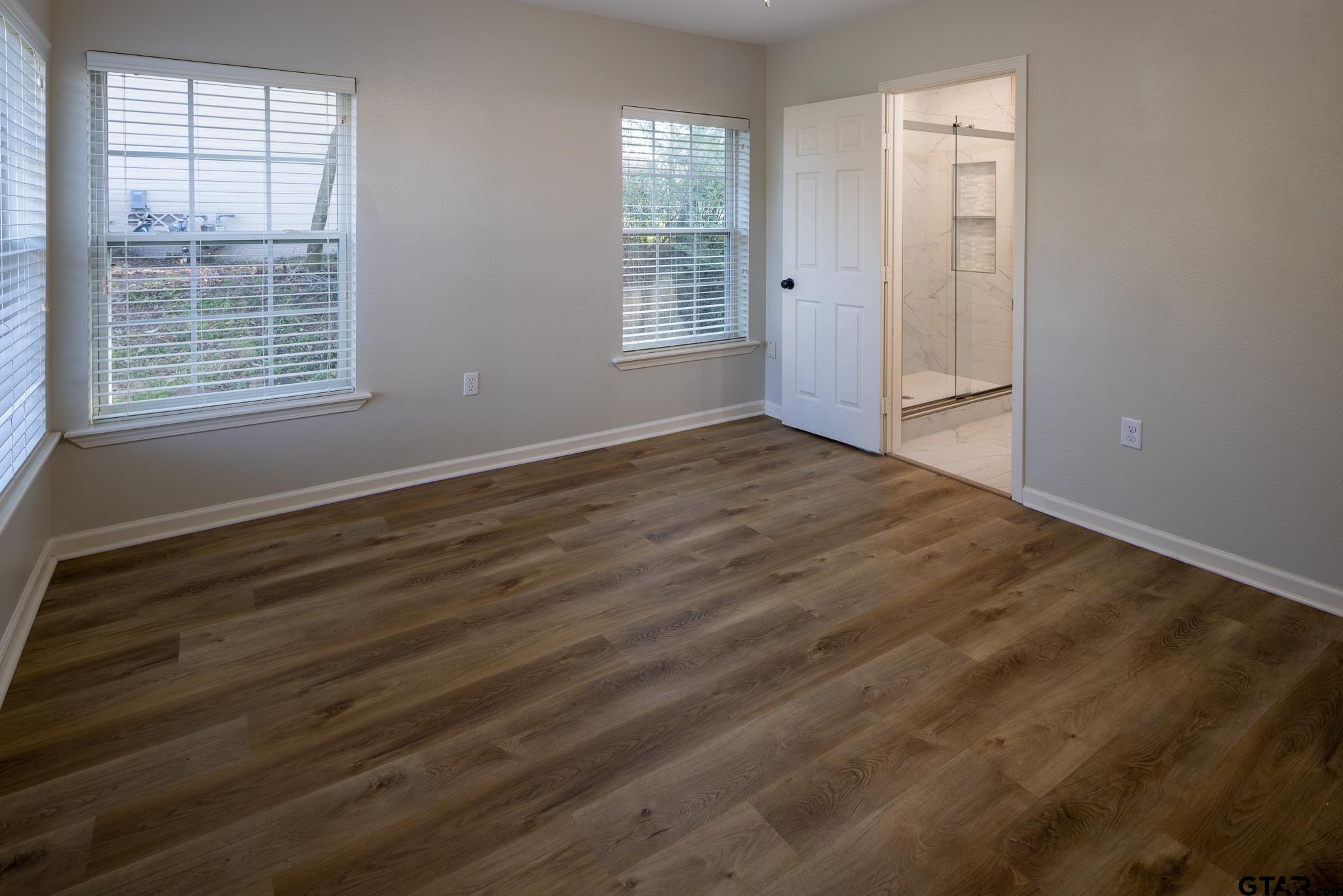 2802 Pollard Drive Tyler, TX 75701 - Photo 21 of 38 a view of an empty room with wooden floor and a window