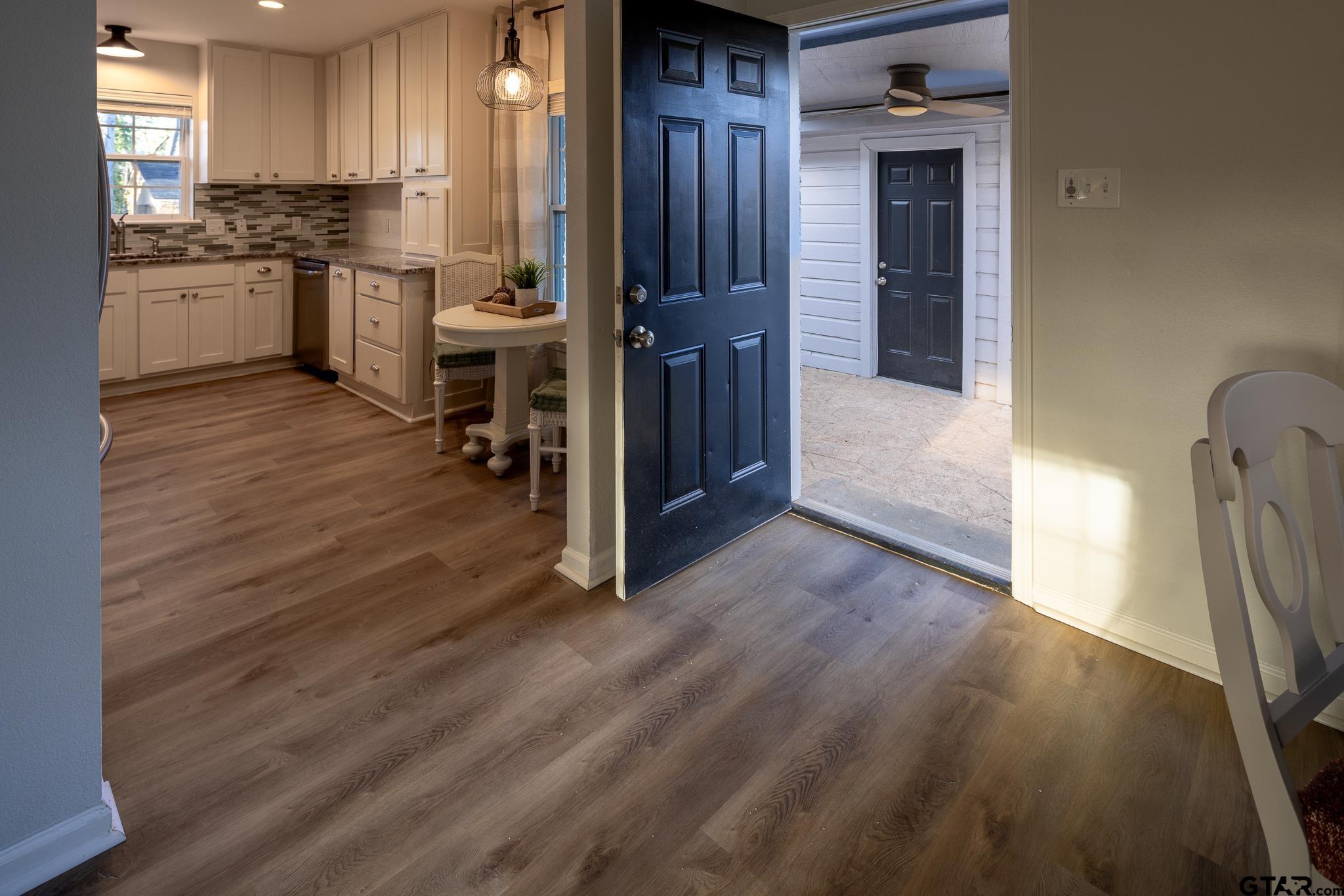 2802 Pollard Drive Tyler, TX 75701 - Photo 25 of 38 a kitchen with a refrigerator and white cabinets