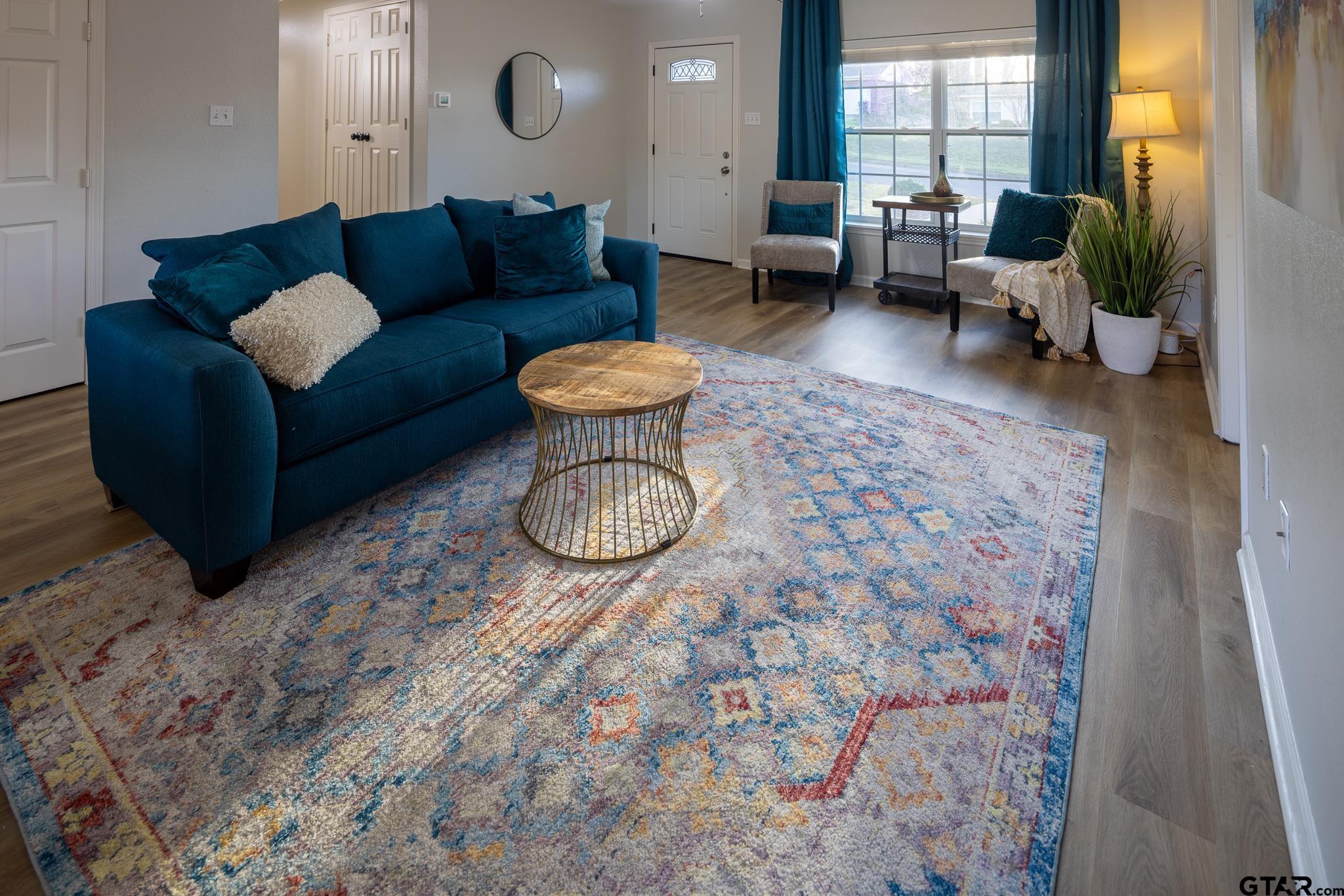 2802 Pollard Drive Tyler, TX 75701 - Photo 3 of 38 a living room with furniture a rug and a floor to ceiling window