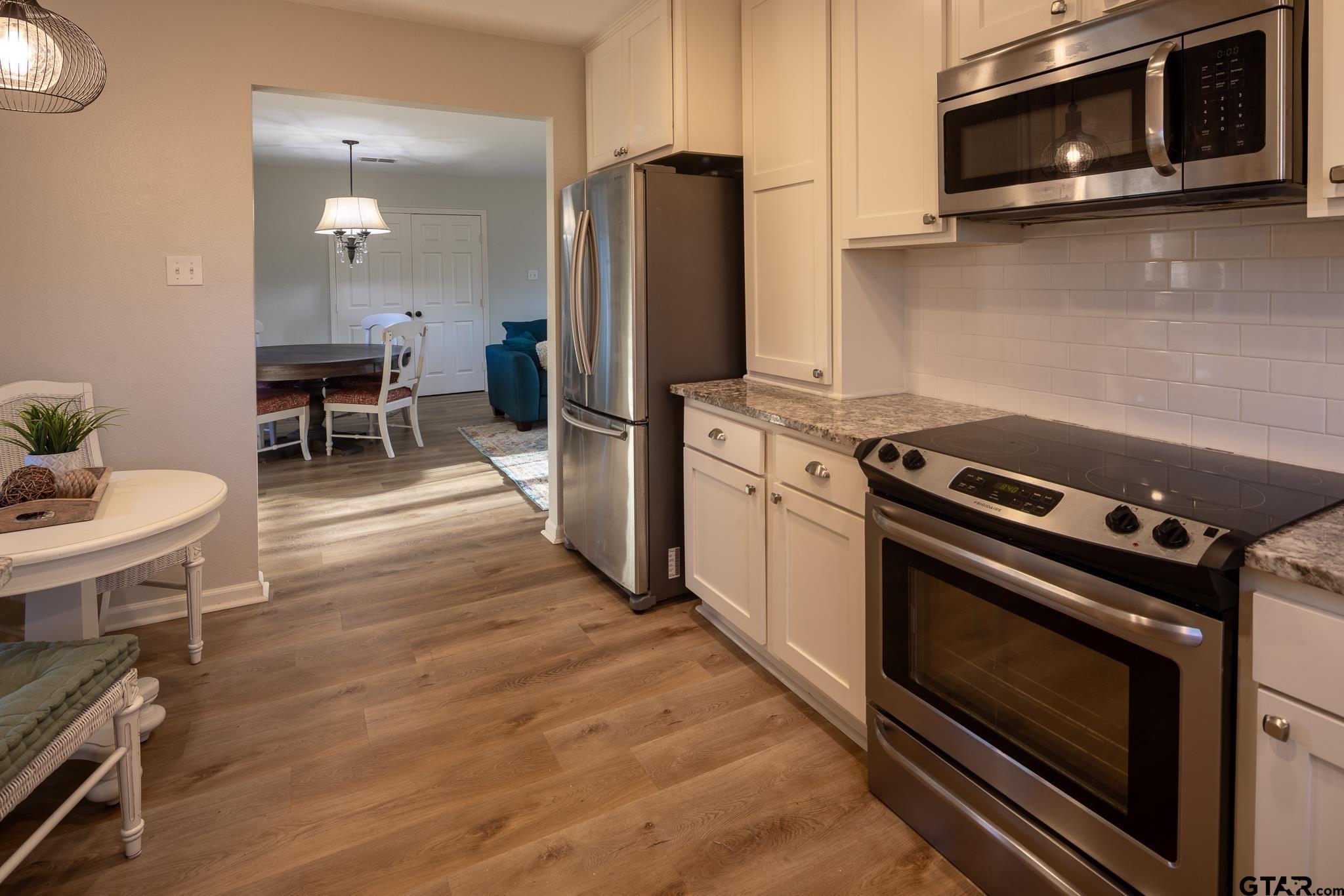 2802 Pollard Drive Tyler, TX 75701 - Photo 10 of 38 a kitchen with a stove a microwave and refrigerator