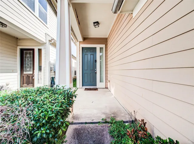 a view of a pathway with house in front of main door