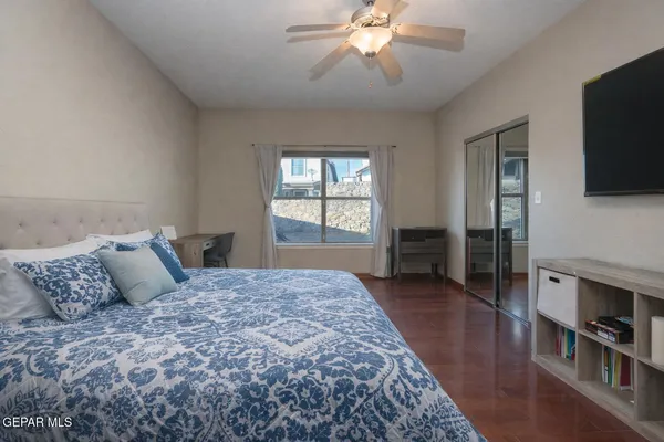 a bedroom with a bed and a chandelier