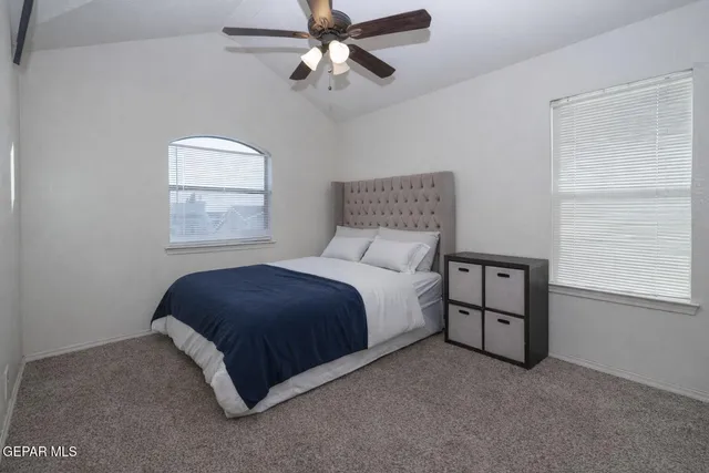 a spacious bedroom with a bed and a window