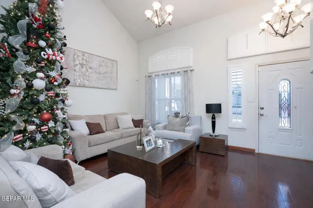 a living room with furniture flowers and a chandelier