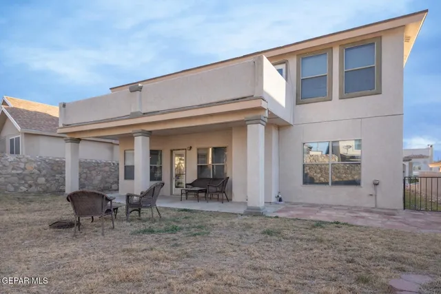 a view of a house with backyard porch and furniture