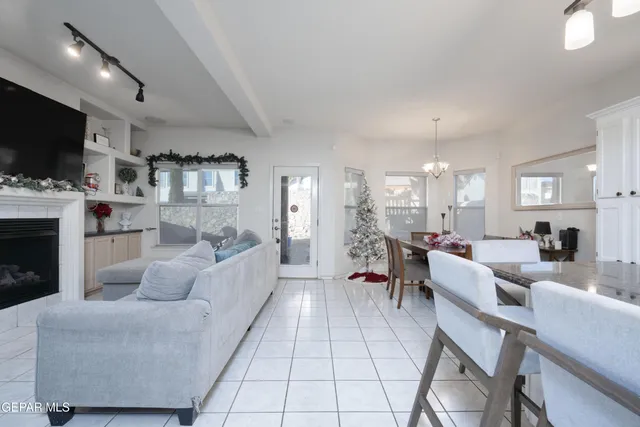 a living room with fireplace furniture and a flat screen tv