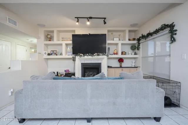a living room with furniture a flat screen tv and a fireplace