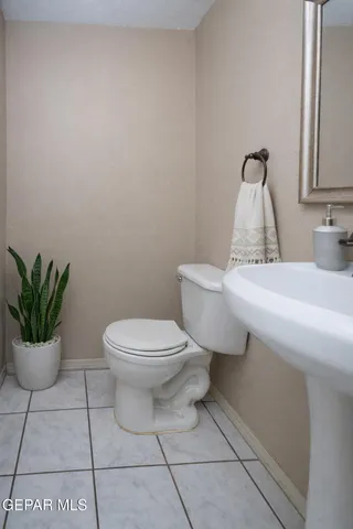 a bathroom with a sink mirror and toilet