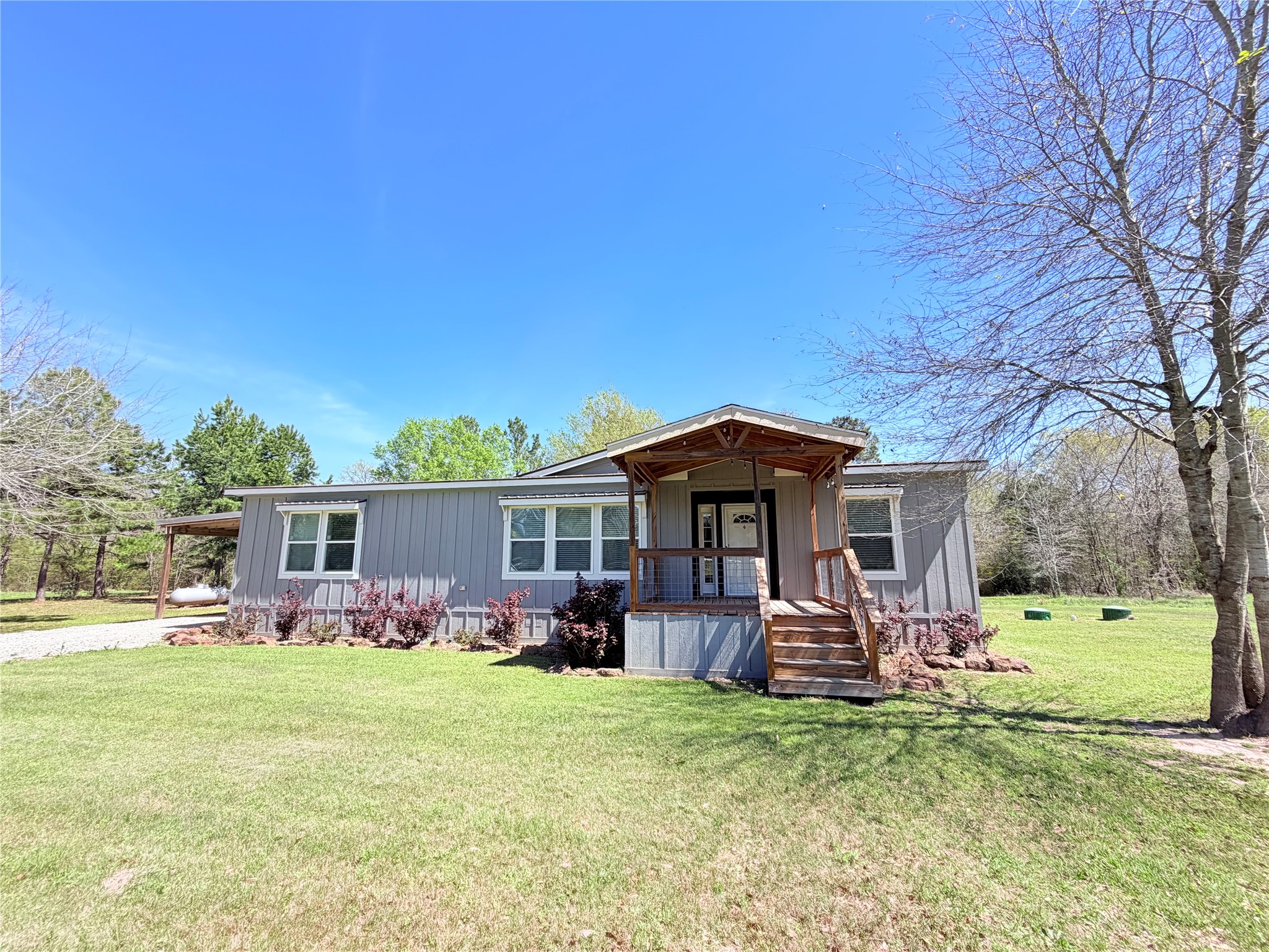 a view of a house with a backyard porch and sitting area