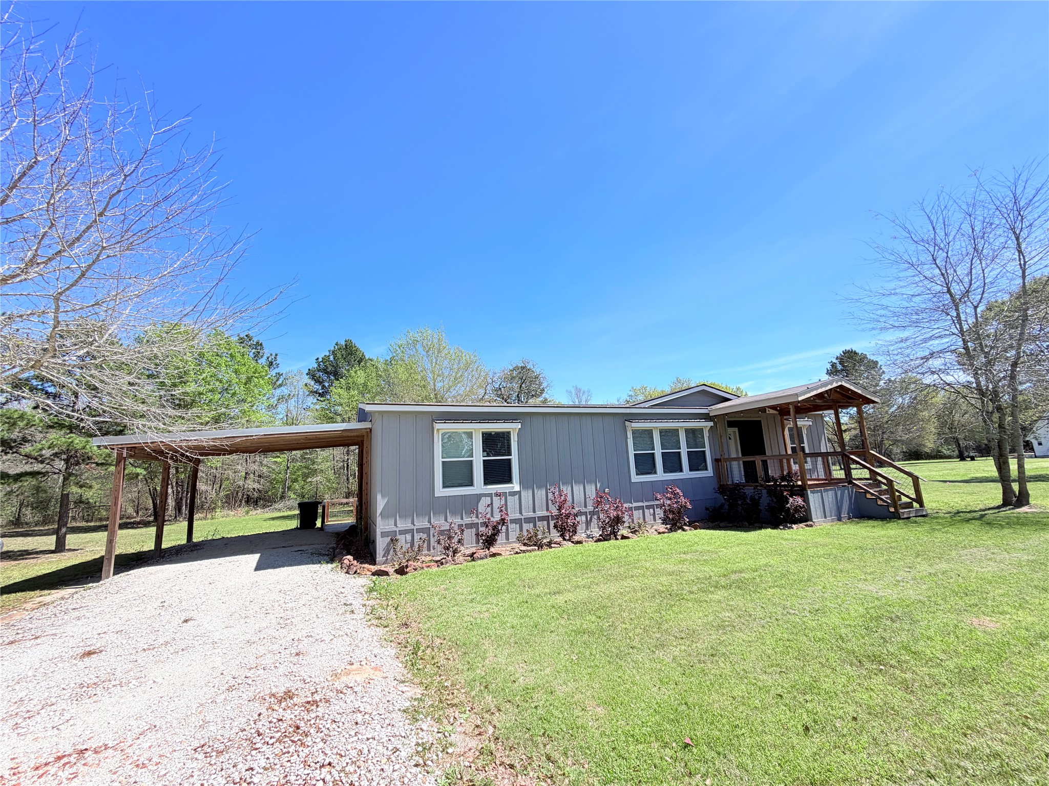 59 Forgotten Road Richards, TX 77873 - Photo 12 of 21 a front view of a house with a yard and potted plants