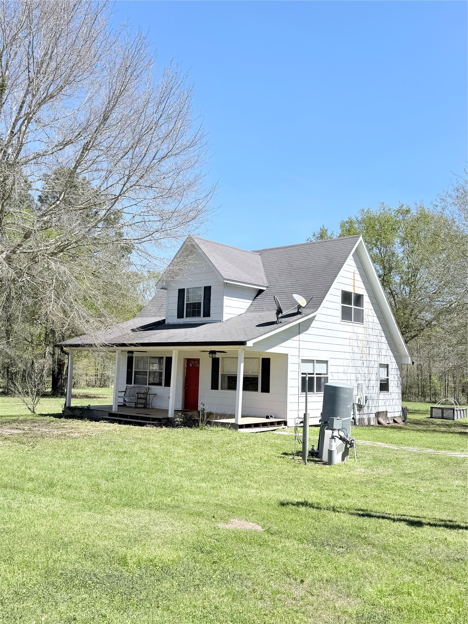 59 Forgotten Road Richards, TX 77873 - Photo 13 of 21 a front view of a house with a garden