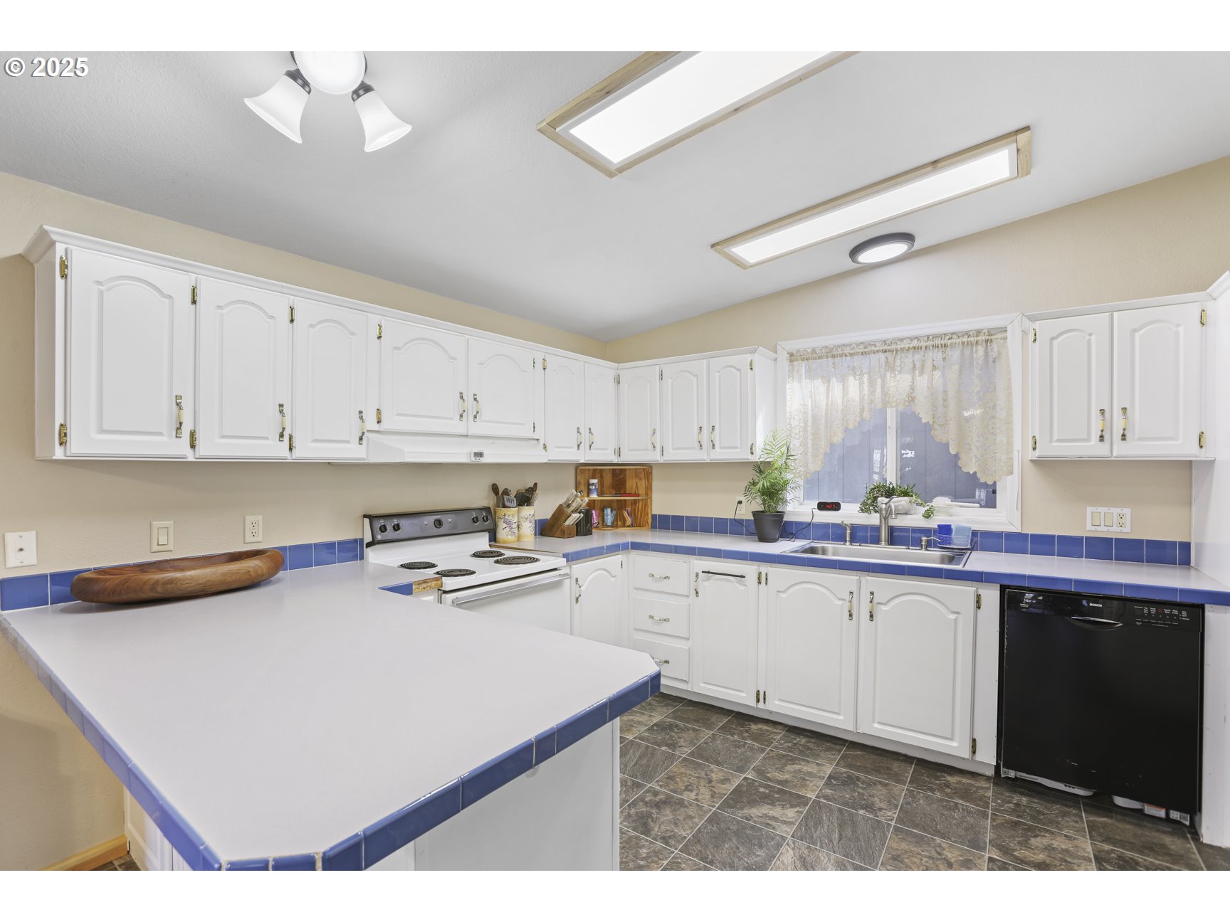 75280 Fern Hill Road Rainier, OR 97048 - Photo 11 of 30 a kitchen with stainless steel appliances a sink a stove a refrigerator and cabinets