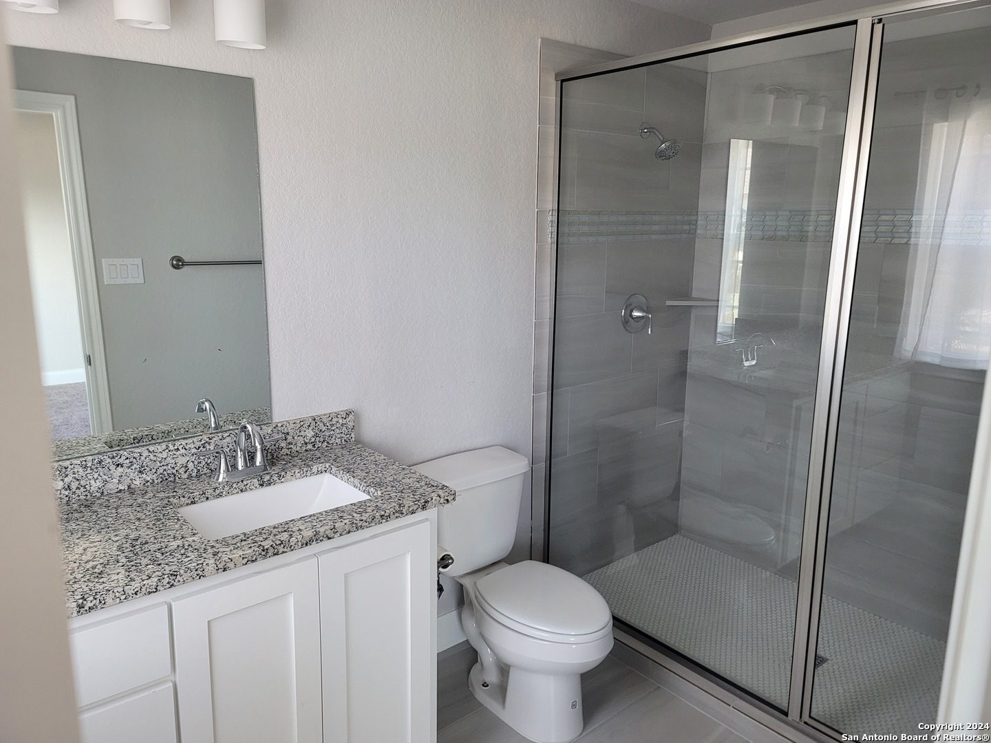 155 Magnolia Circle Boerne, TX 78006 - Photo 12 of 15 a bathroom with a granite countertop sink toilet and shower