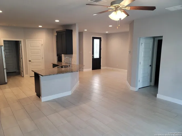 a view of a kitchen with a sink and a large mirror